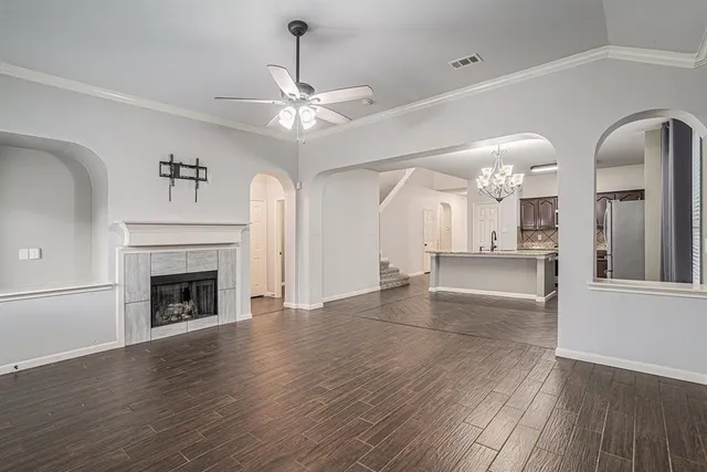 wooden floor fireplace and windows in an empty room
