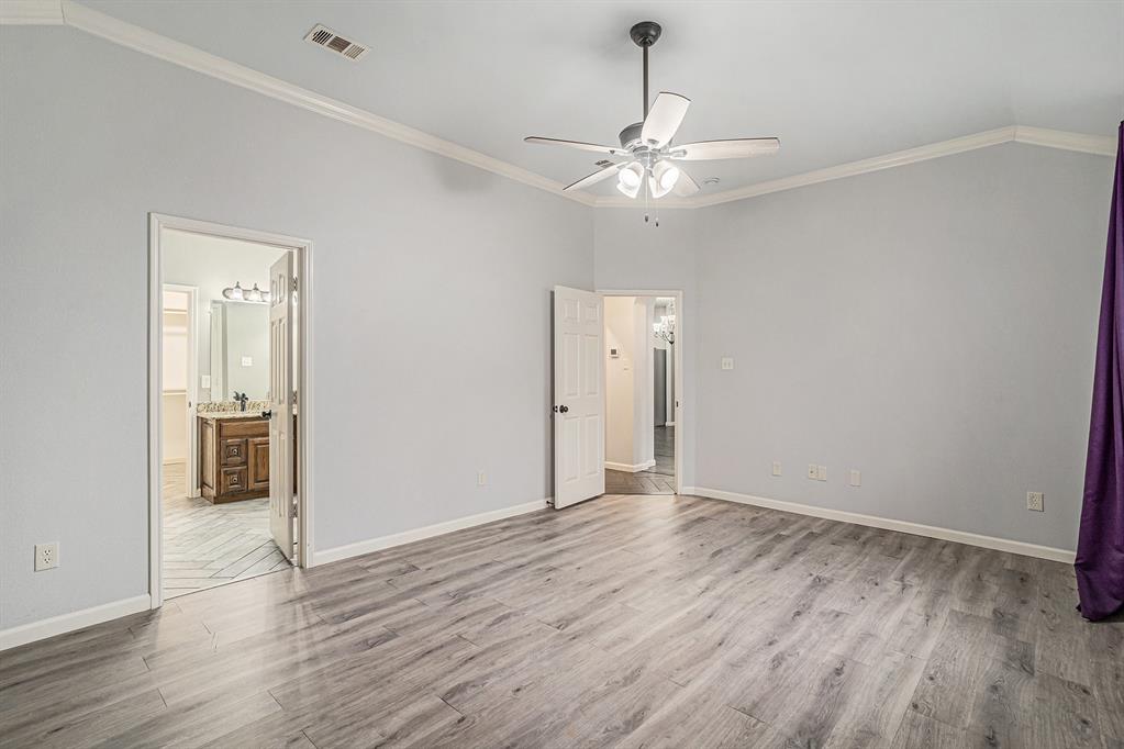 10005 Shelburne Road Fort Worth, TX 76244 - Photo 15 of 26 a view of an empty room with wooden floor