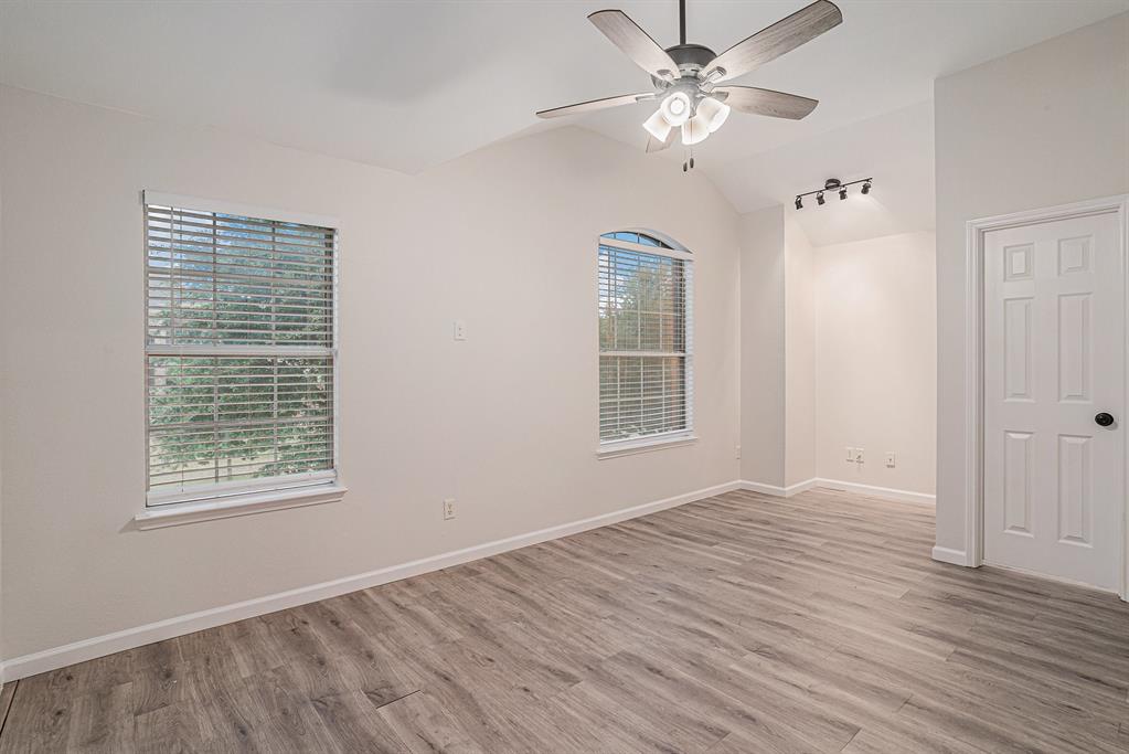 10005 Shelburne Road Fort Worth, TX 76244 - Photo 20 of 26 wooden floor in an empty room with a window