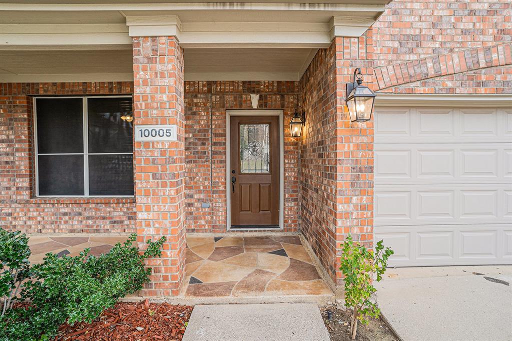 10005 Shelburne Road Fort Worth, TX 76244 - Photo 2 of 26 a front view of a house with a blue gate