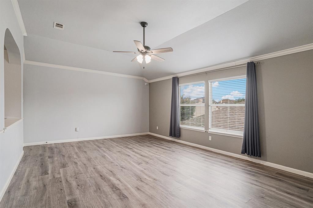 10005 Shelburne Road Fort Worth, TX 76244 - Photo 21 of 26 a view of an empty room with a window and a ceiling fan