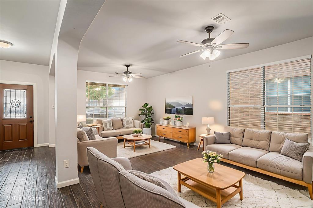 10005 Shelburne Road Fort Worth, TX 76244 - Photo 3 of 26 a living room with furniture a ceiling fan a fireplace and a window