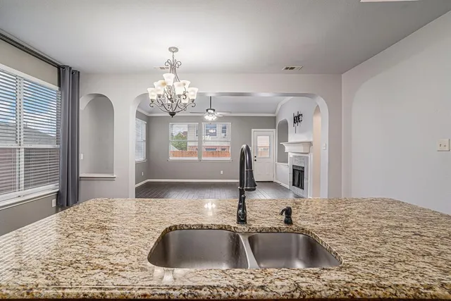 a kitchen with kitchen island a sink and a large mirror