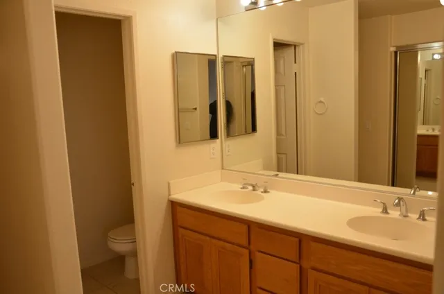 a bathroom with a double vanity sink and a mirror