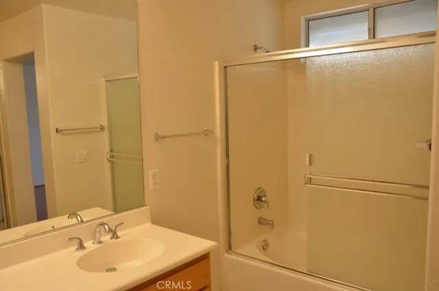 a bathroom with a shower and a sink