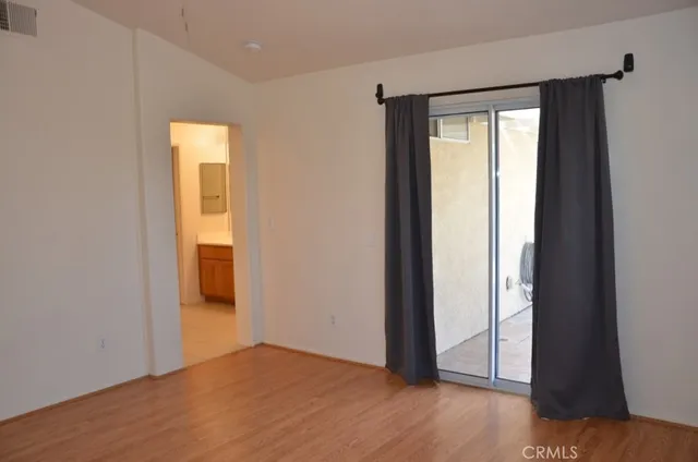 a view of a room with wooden floor and bathroom