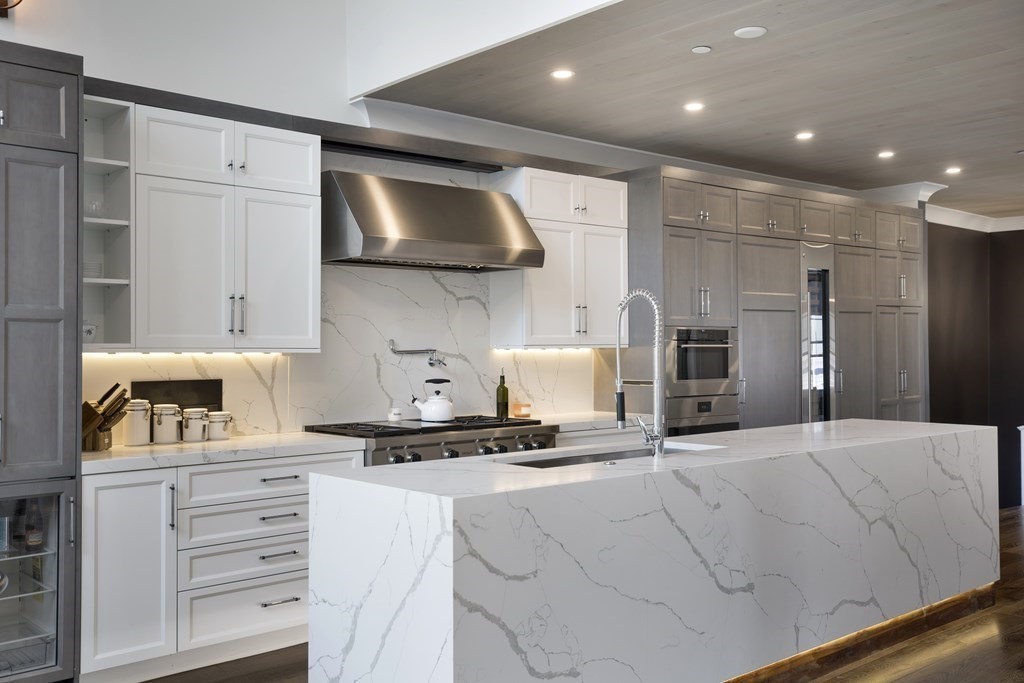 719 East 2nd Street, Unit PH3 Boston, MA 02127 - Photo 13 of 38 a kitchen with kitchen island a stove a sink and a refrigerator