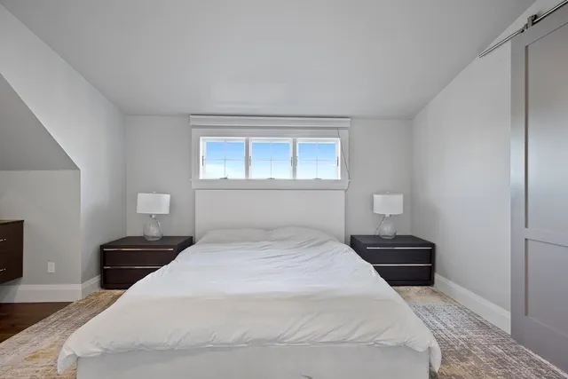 a bedroom with a bed and a lamp