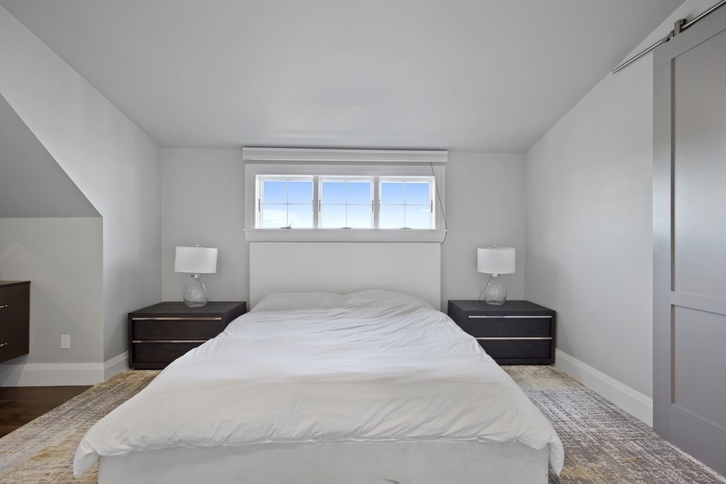 719 East 2nd Street, Unit PH3 Boston, MA 02127 - Photo 17 of 38 a bedroom with a bed and a lamp