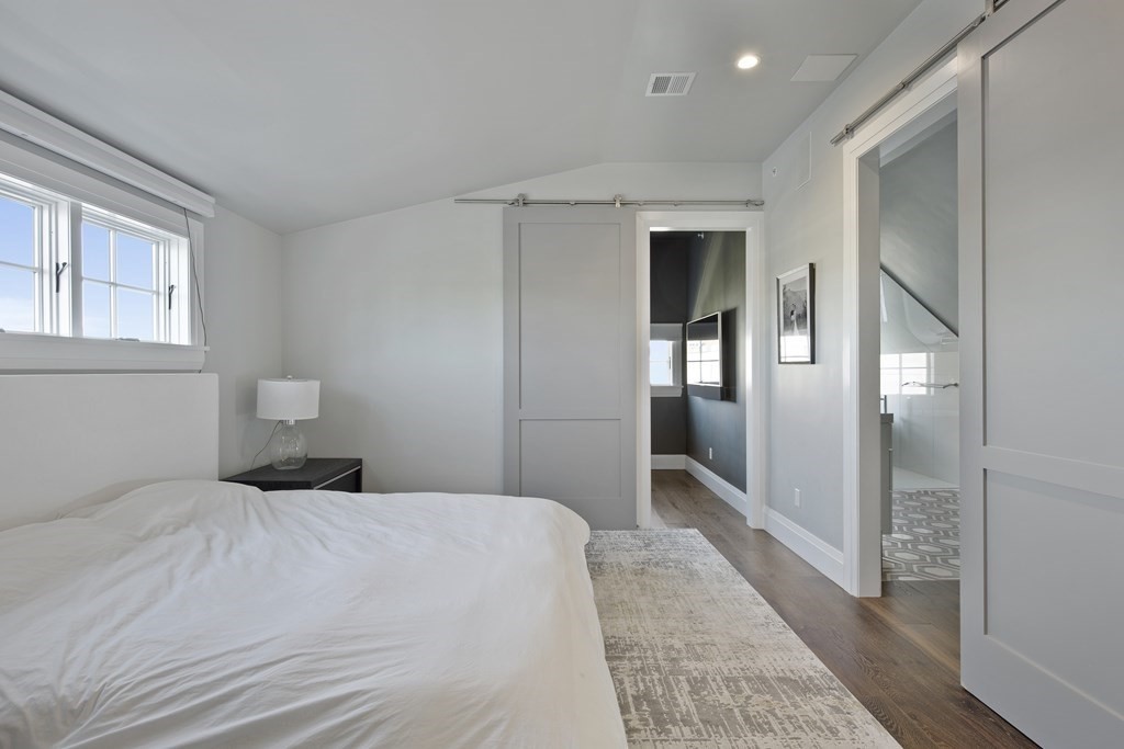 719 East 2nd Street, Unit PH3 Boston, MA 02127 - Photo 18 of 38 a bedroom with a bed and a mirror