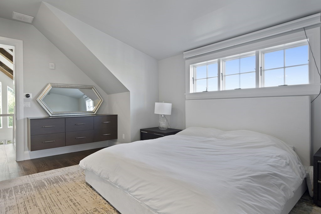 719 East 2nd Street, Unit PH3 Boston, MA 02127 - Photo 22 of 38 a bedroom with a large bed and a dresser