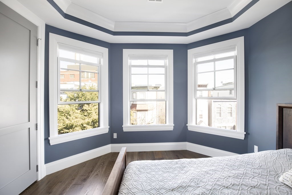 719 East 2nd Street, Unit PH3 Boston, MA 02127 - Photo 24 of 38 a bedroom with a bed and wooden floor