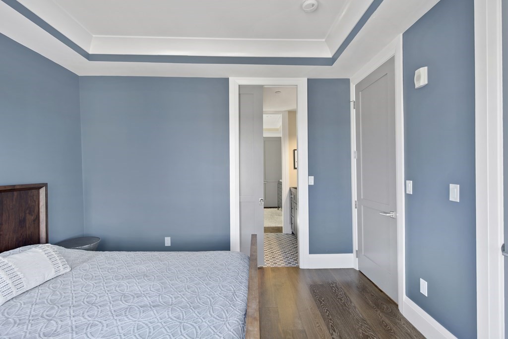 719 East 2nd Street, Unit PH3 Boston, MA 02127 - Photo 25 of 38 a bedroom with a bed and wooden floor