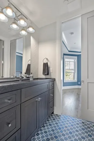 a bathroom with a sink a vanity and a large mirror