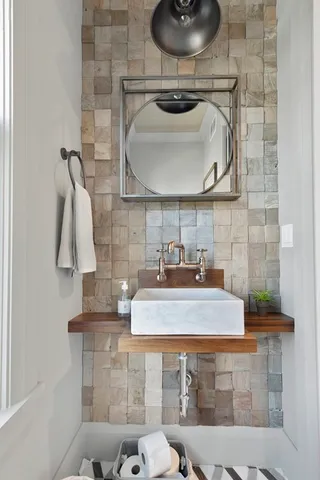 a bathroom with a sink a toilet and mirror