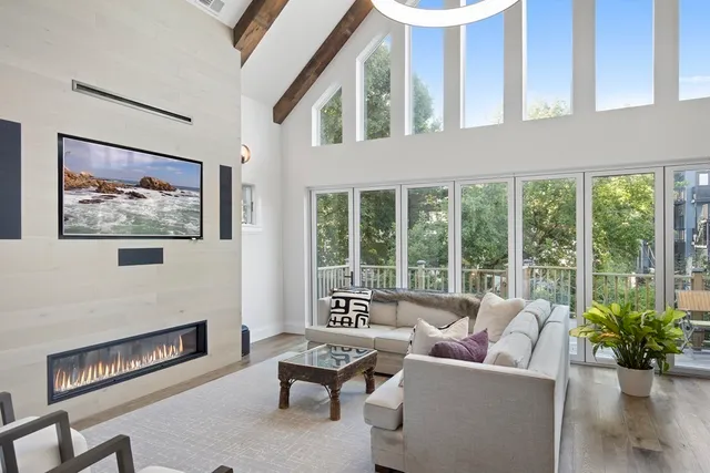 a living room with furniture and a floor to ceiling window