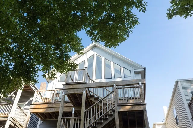 a view of a house with backyard and deck