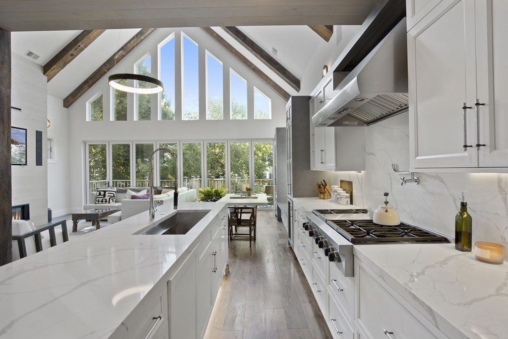 719 East 2nd Street, Unit PH3 Boston, MA 02127 - Photo 7 of 38 a kitchen with a stove a sink and a refrigerator