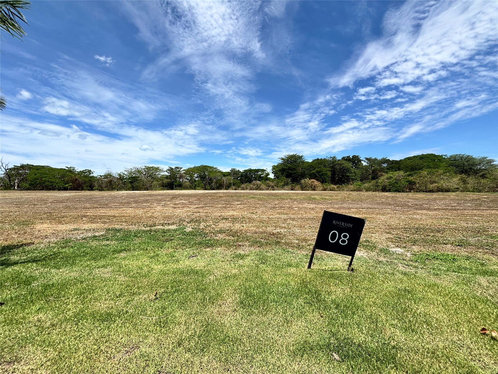 a view of a lake with houses in the back