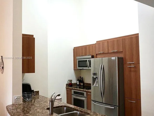 a bathroom with a granite countertop sink mirror vanity and toilet
