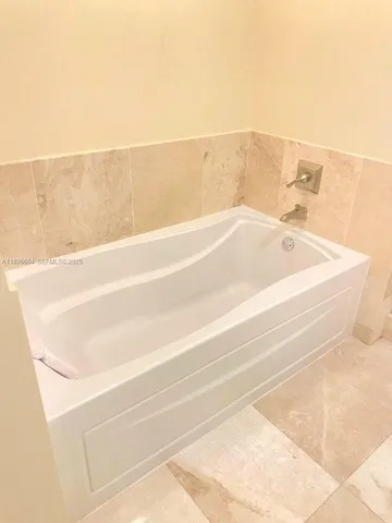 a bathroom with a bathtub and shower