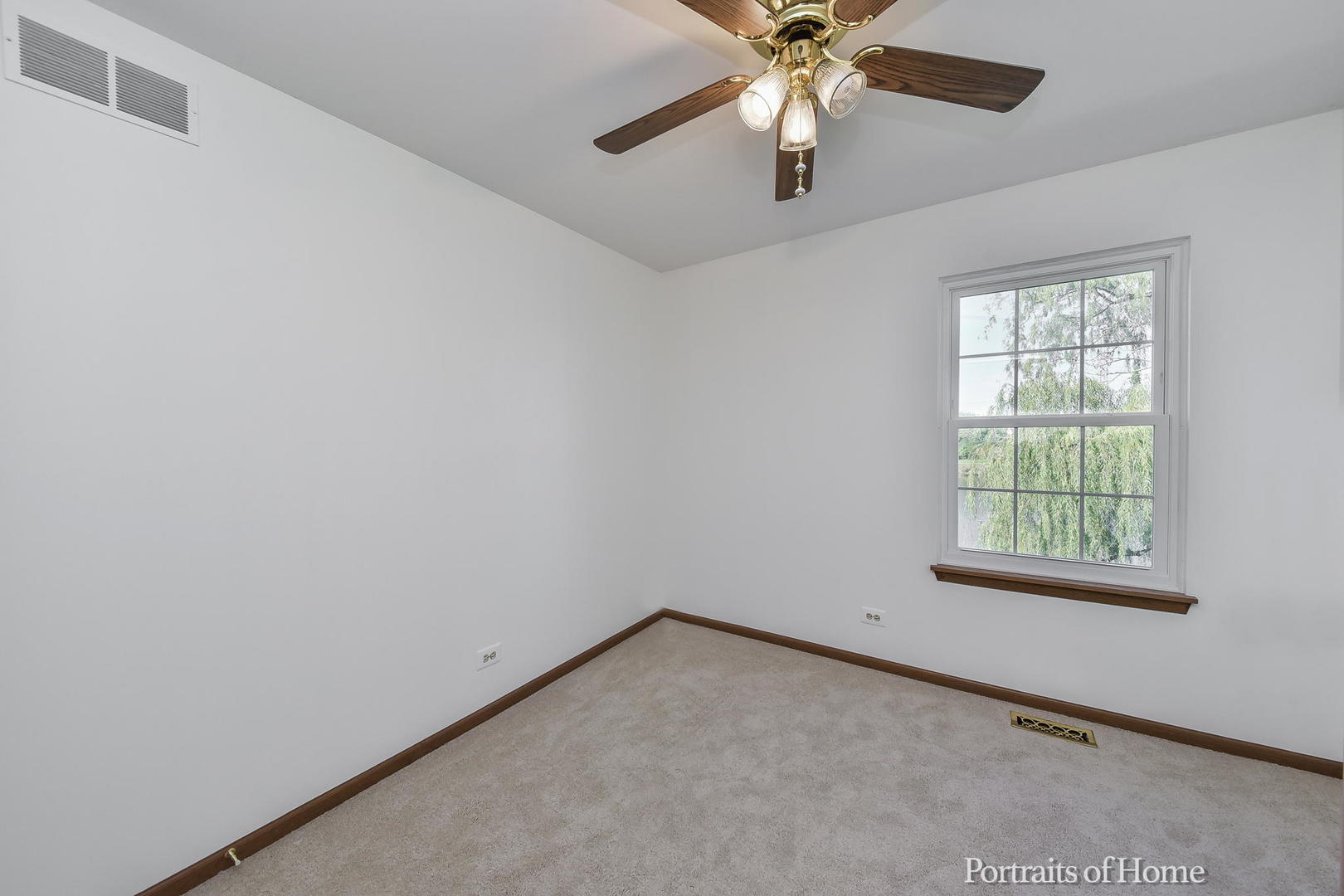 75 St Croix Court Aurora, IL 60504 - Photo 13 of 20 an empty room with a window and a fan