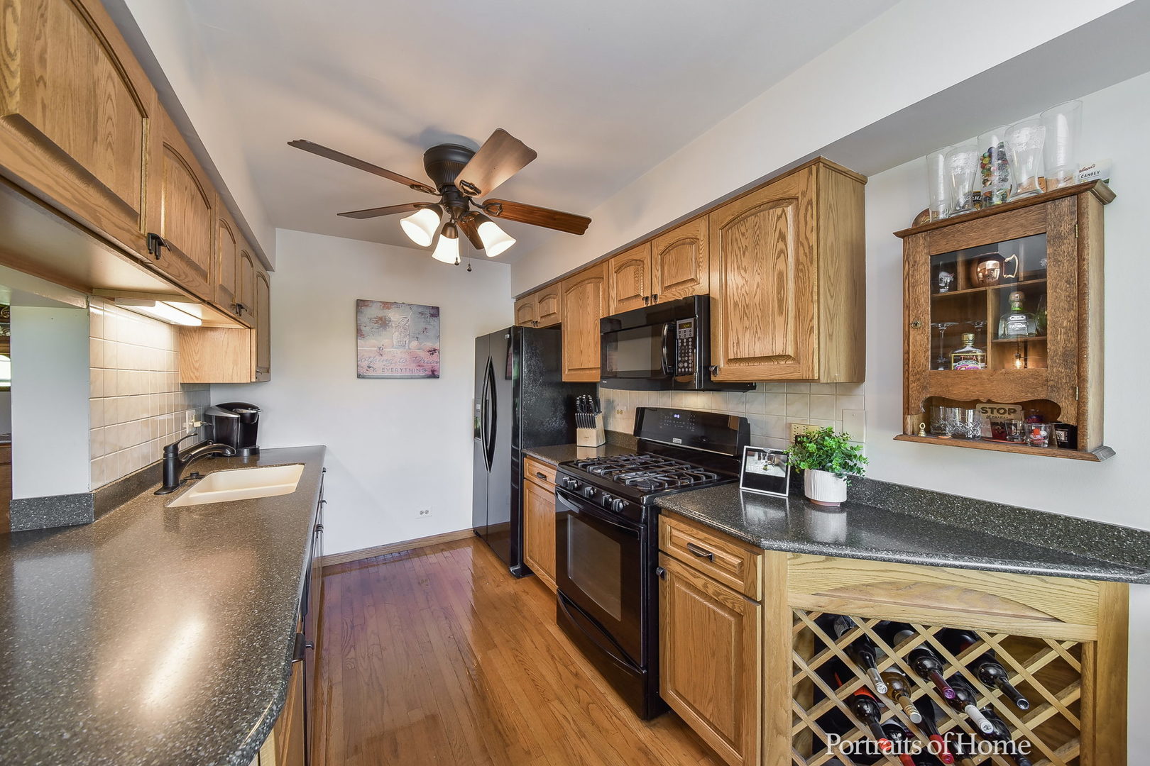 75 St Croix Court Aurora, IL 60504 - Photo 8 of 20 a kitchen with stainless steel appliances granite countertop a stove top oven a sink dishwasher a dining table and chairs with wooden floor