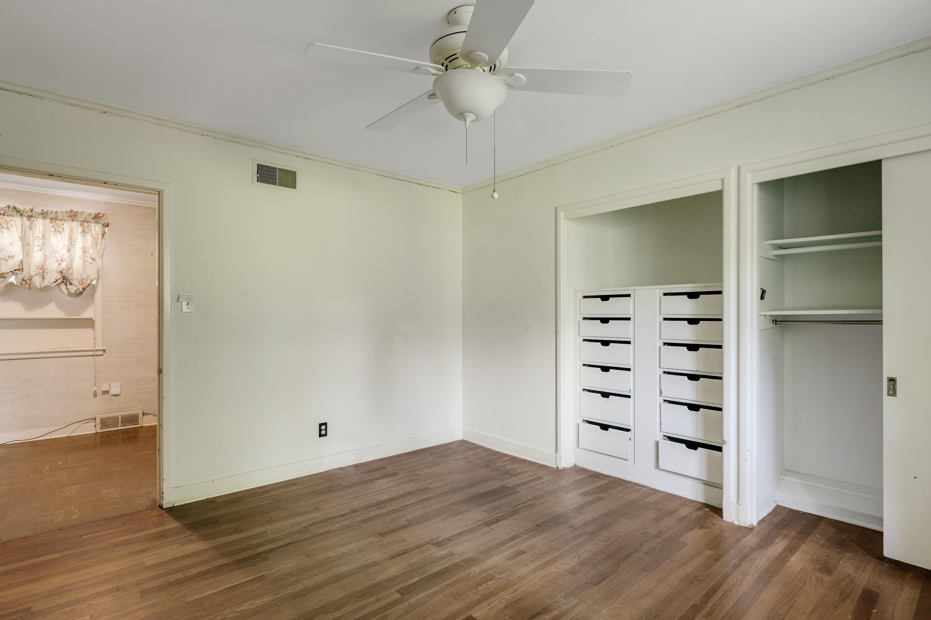 4356 Tuckahoe Road Memphis, TN 38117 - Photo 13 of 25 a view of a bedroom with a hardwood floor and a ceiling fan