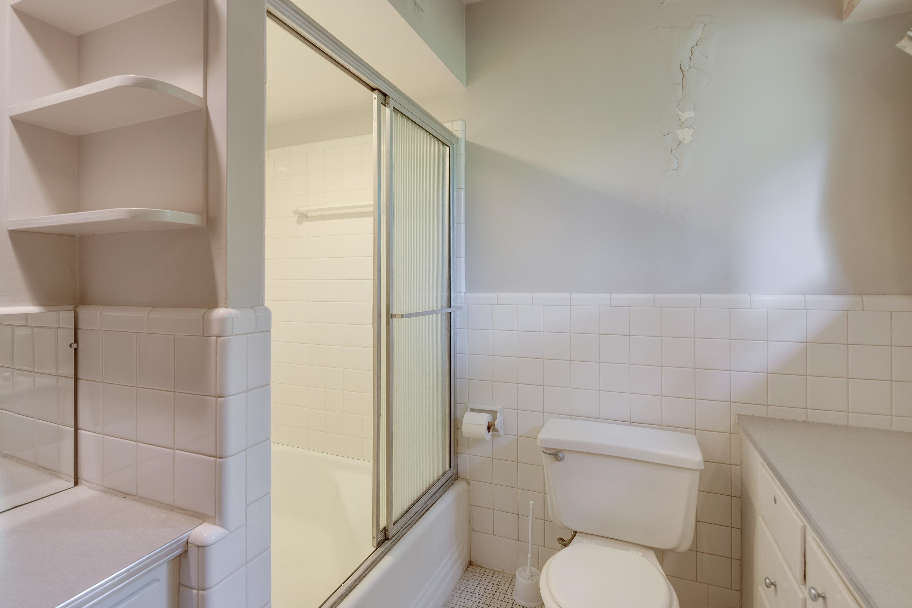 4356 Tuckahoe Road Memphis, TN 38117 - Photo 17 of 25 a white toilet sitting next to a bathroom sink