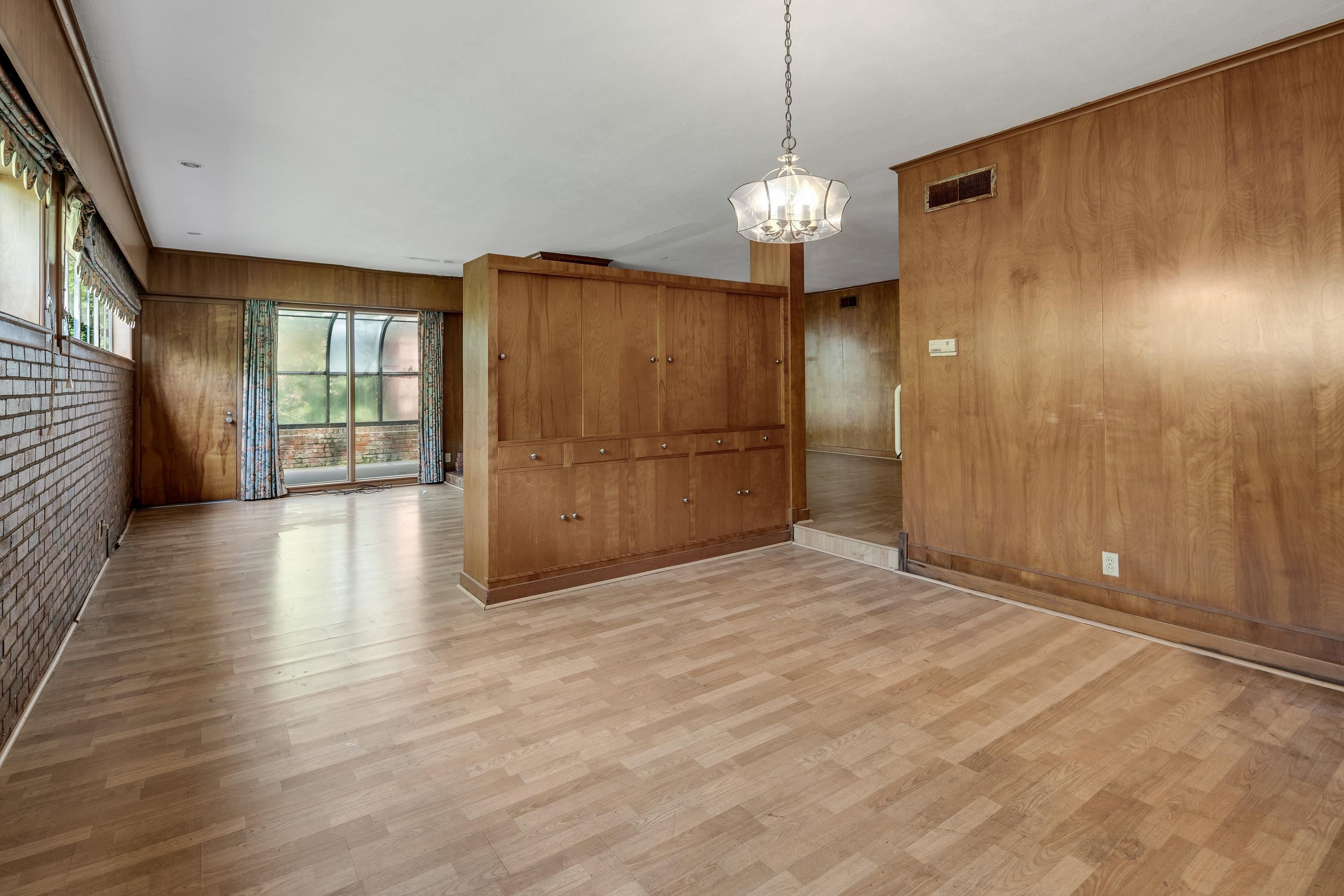 4356 Tuckahoe Road Memphis, TN 38117 - Photo 8 of 25 a view of an empty room with wooden floor and a window