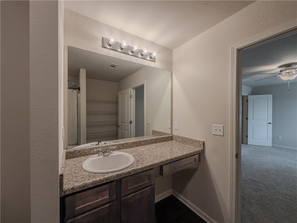 206 Morning Drive Athens, GA 30606 - Photo 17 of 36 a bathroom with a granite countertop sink a mirror and vanity