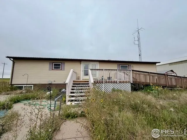 a view of a front door and wooden fence