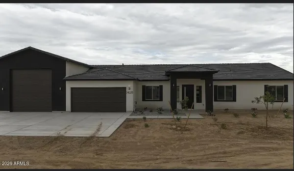 a front view of a house with yard