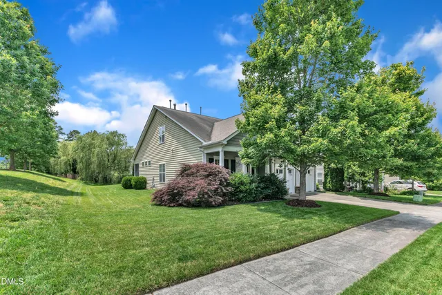 a view of a house with yard and a garden