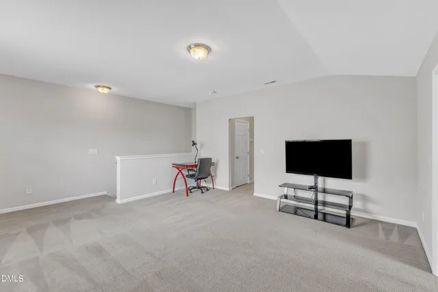 a view of a backyard with table and chairs and potted plants