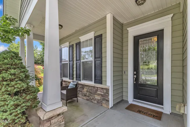 a living room with flat screen tv and a window
