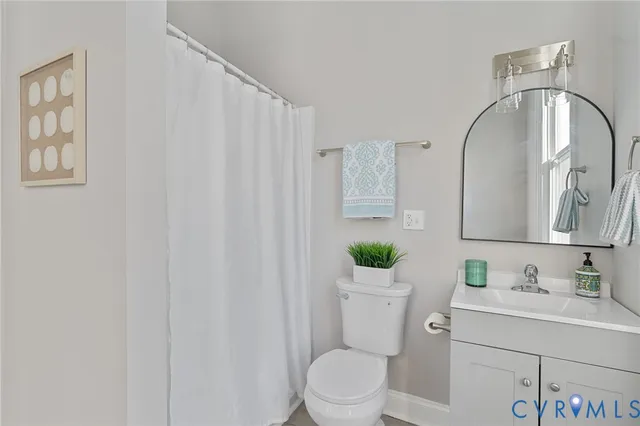 a living room with furniture a window and a fireplace