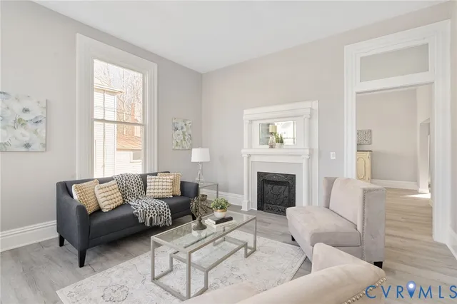 a living room with furniture and a fireplace