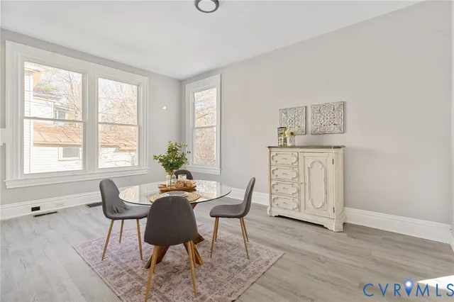 a dining room with furniture and wooden floor