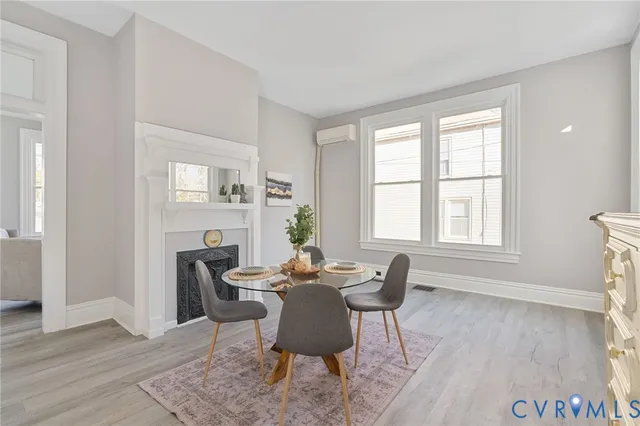a living room with furniture a fireplace and a window
