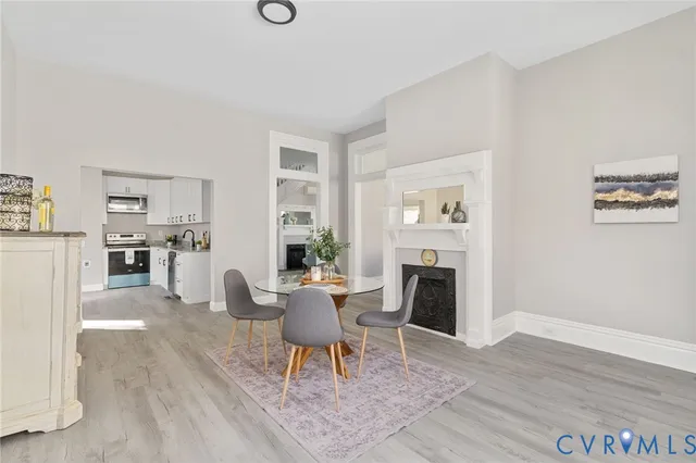 a dining room with furniture and a kitchen space