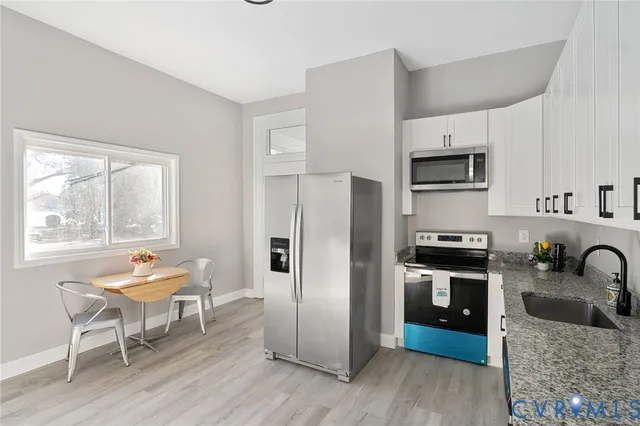 a view of a dining room with furniture and window