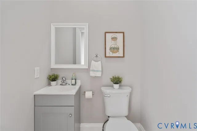 a bathroom with a toilet a sink and a mirror