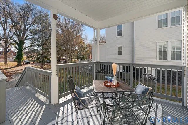 a view of yard with wooden fence and large trees