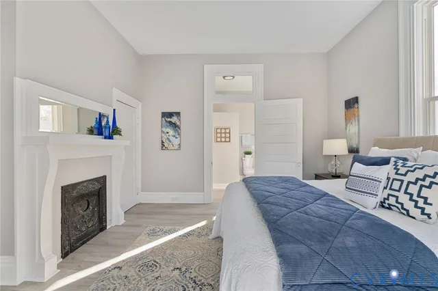 a spacious bedroom with a bed and a fireplace