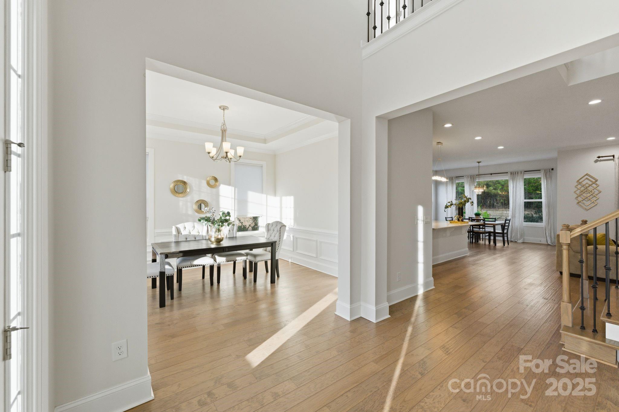 374 Hampton Trail Drive Fort Mill, SC 29708 - Photo 15 of 48 a view of a dining room and livingroom with furniture wooden floor a chandelier