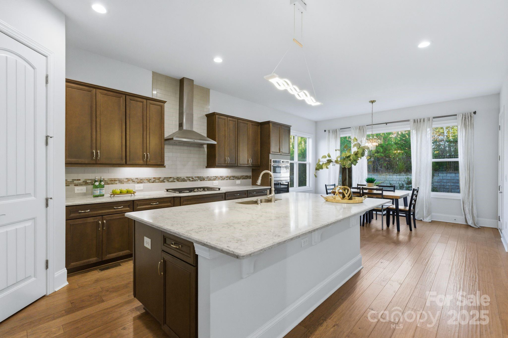 374 Hampton Trail Drive Fort Mill, SC 29708 - Photo 17 of 48 a kitchen with a stove a sink dishwasher a refrigerator with wooden cabinets and wooden floor