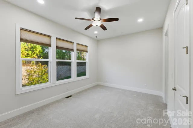 a view of a porch with wooden floor and yard in the back