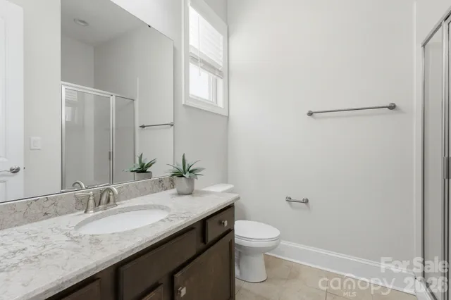 a spacious bedroom with a bed and a large window