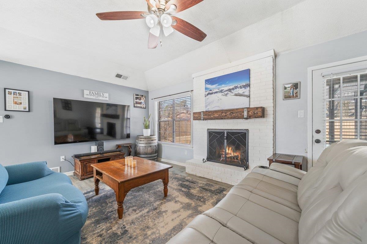 6310 Prairie View Drive Bartlett, TN 38134 - Photo 12 of 27 a living room with furniture a flat screen tv and a fireplace